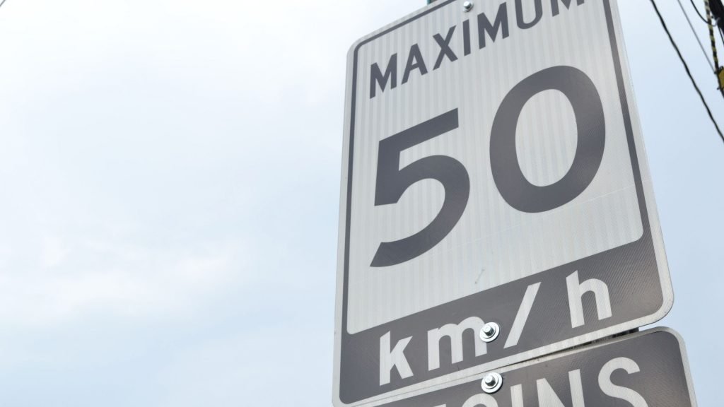 Street sign indicating a speed limit of 50 km/h to illustrate the point that traffic laws are negative reinforcement in action.
