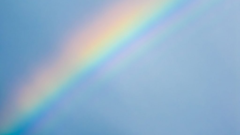Rainbow across a blue sky symbolizing the Rainbow Bridge pets cross when they pass on.